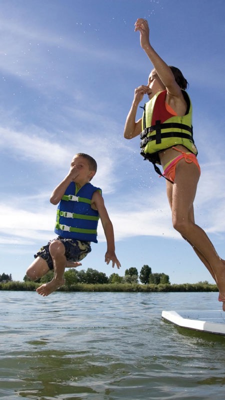 Children Jumping Into Water