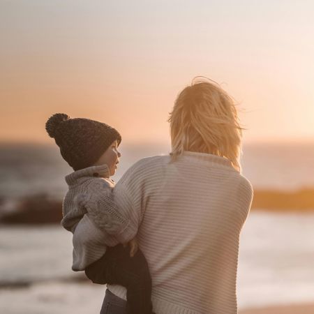 Mother Holding a Child at the Beach