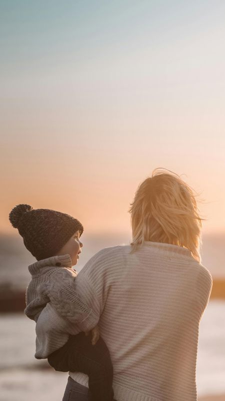 Mother Holding a Child at the Beach