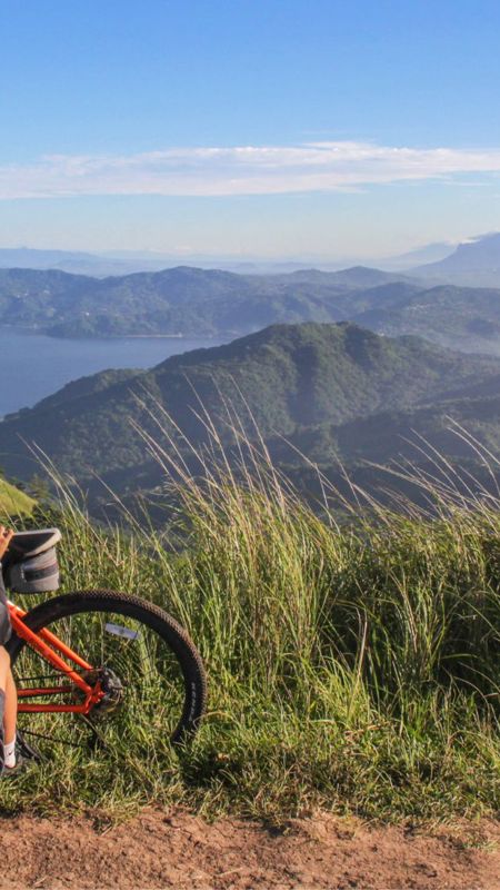 Cyclist enjoying view from the top of the mountain 