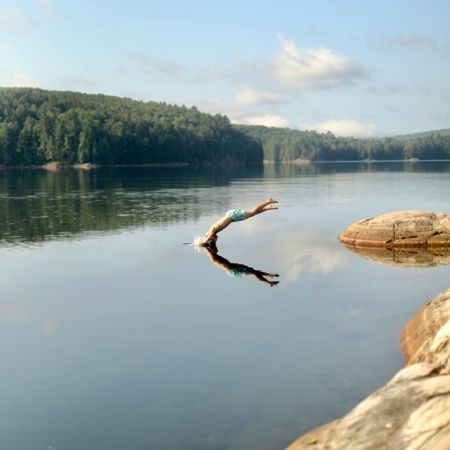 Person jumping into the lake